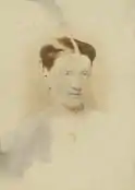 A photograph of Margaret Macpherson Grant, wearing a white shirt and a necklace