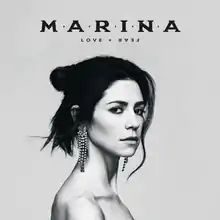 A greyscale photograph of Marina facing sideways, while gazing into the camera. Above her, the album's title and her name are placed in black lettering.