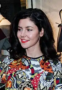 A color photograph of Welsh singer Marina Diamandis posing for a store opening event in 2014.