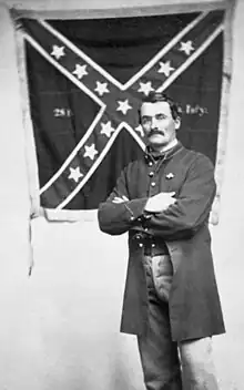 Sherman poses with the 28th Virginia battle flag in 1864