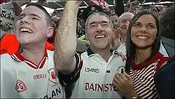 Photo of Michaela Harte at right, with father Mickey Harte centre, and brother Matthew at left, celebrating Tyrone's 2003 football final win