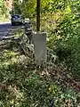 Granite marker pointing to the Boon Monument about 150 feet from the road in Stow Massachusetts