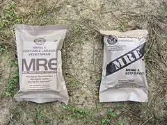 A pair of Meal, Ready-to-Eat (MRE) field rations packaged in retort pouches