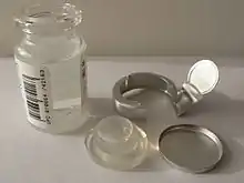 Tearable metal band on pharmaceutical bottle