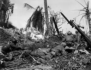 Soldiers of the U.S. 7th Infantry Division attack a Japanese blockhouse on Kwajalein