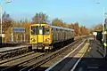 A Merseyrail Class 507 departs with a service.