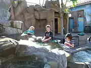 Children in the interactive gold panning exhibit.