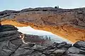 Washer Woman framed by Mesa Arch