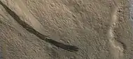 Dark slope streaks along a mesa wall, as seen by HIRISE  Picture is about 1 km across.