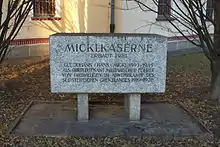 a photograph of a stone plaque with engraved writing