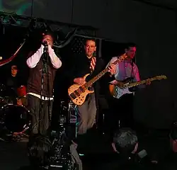 Republican presidential candidate Mike Huckabee (center) performs with his band "Capitol Offense" at the Republican Party of Iowa's Lincoln Day Dinner on April 14, 2007.