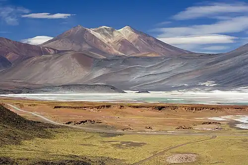 Stark mountains in background, with salt flats in foreground