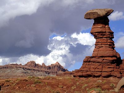 Hoodoo within the Chinle Formation, west of Moab, Utah, along the Chicken Corners off-road trail. Ridge in background is part of the Wingate Sandstone.