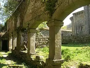 Ruined cloister of Sanfins de Friestas Church, with short arcades.