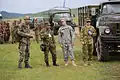 Czech, Japanese, American, and Australian soldiers before a convoy during Khaan Quest 2013