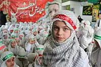 Iranian children wearing the keffiyeh during a religious gathering in Iran; keffiyeh has only a religious usage in Iran.