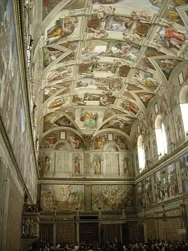 A tall, narrow room with a highly detailed painted ceiling depicting Bible scenes