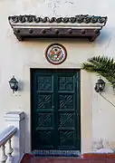 Dark green door on a white building