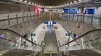 View of the concourse level with the elliptical motif, with an open view of the platform below