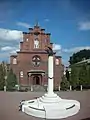 A memorial to the victims of political repressions and the Exaltation of the Holy Cross Church.