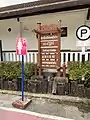 Station sign in various languages and female-only parking sign