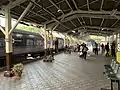 Platform with a train arriving from Bangkok