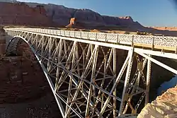 Cathedral Rock left of center (illuminated) above Navajo Bridge, Vermilion Cliffs National Monument further in the distance.