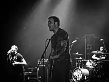 New Found Glory performing onstage playing and singing into a microphone