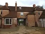 New Inn Farmhouse with outbuildings behind