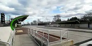 A bus station with two curved canopies