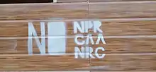 Graffito of NPR-CAA-NRC in spray paint