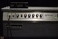 The front control panel of an Ampeg SVT amplifier is shown. Several control knobs are shown.