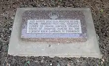 Stone marker with embedded bronze disc; marker reads "This bronze disc is a replica of the actual marker for the geodetic center of North America, located south of Osborne.  Placed by the Osborne Area Chamber of Commerce."