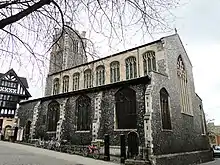 A stone church seen from the southeast, showing the south aisle, clerestory, and west tower