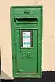 George V wall box showing small red specks under the green paint at Tullamore