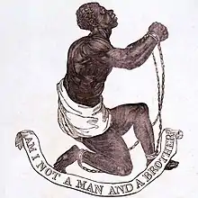 Drawing which shows a slave kneeling and holding up his clasped and manacled hands. Underneath him, a banner says "Am I Not a Man and a Brother?"