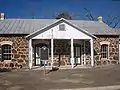 The Old Rock Schoolhouse, built of locally procured red sandstone, housed the First Baptist Church (located next door) from 1875 to 1883.