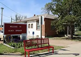 Olney Springs' town hall and welcome sign.