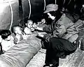 Orphans receive candy from Flight Nurse Capt. Mary Spivak