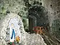 Our Lady of Lourdes Grotto at the foot of the bell tower