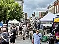 Shoppers and stalls at St Albans Market outside of the Museum.