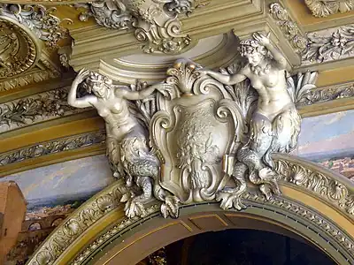 Beaux Arts mermaid caryatids with a cartouche in Le Train Bleu, Gare de Lyon, Paris, 1901, by Marius Toudoire