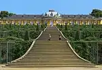 Single story pale yellow ornate palace stretching from the left foreground to the right background