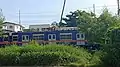 PNR EMU 06 in blue and orange livery near Sucat station, with polycarbonate windows and air-conditioning units from PT INKA (December 2020)