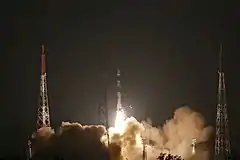 A PSLV-DL launch vehicle lifts off during nighttime