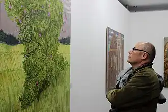 A man admiring a painting