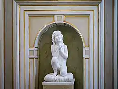 Kneeling child at prayer in the Palazzo Tosio, Brescia