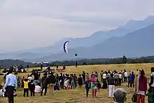 Spectators and a paraglider