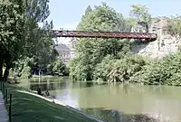 A 63-meter long suspension bridge, designed by Gustave Eiffel in 1867,  allows access to the island in the lake.