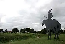 Local artist and photographer, Michael Klemme, erected metal statues commemorating the land run featuring longhorn cattle, a stage coach, horses, and a Native American mounted on a horse.